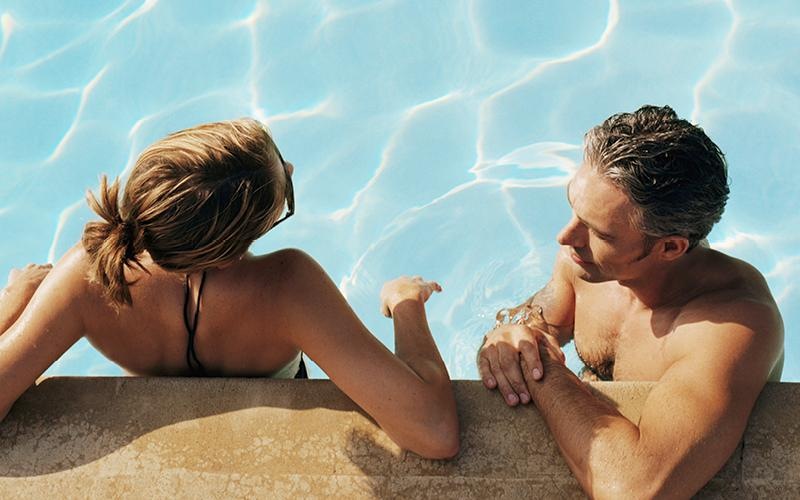 a man and a woman sitting on a beach