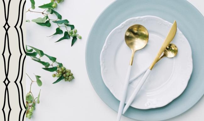 a plate with a spoon and a plant on it