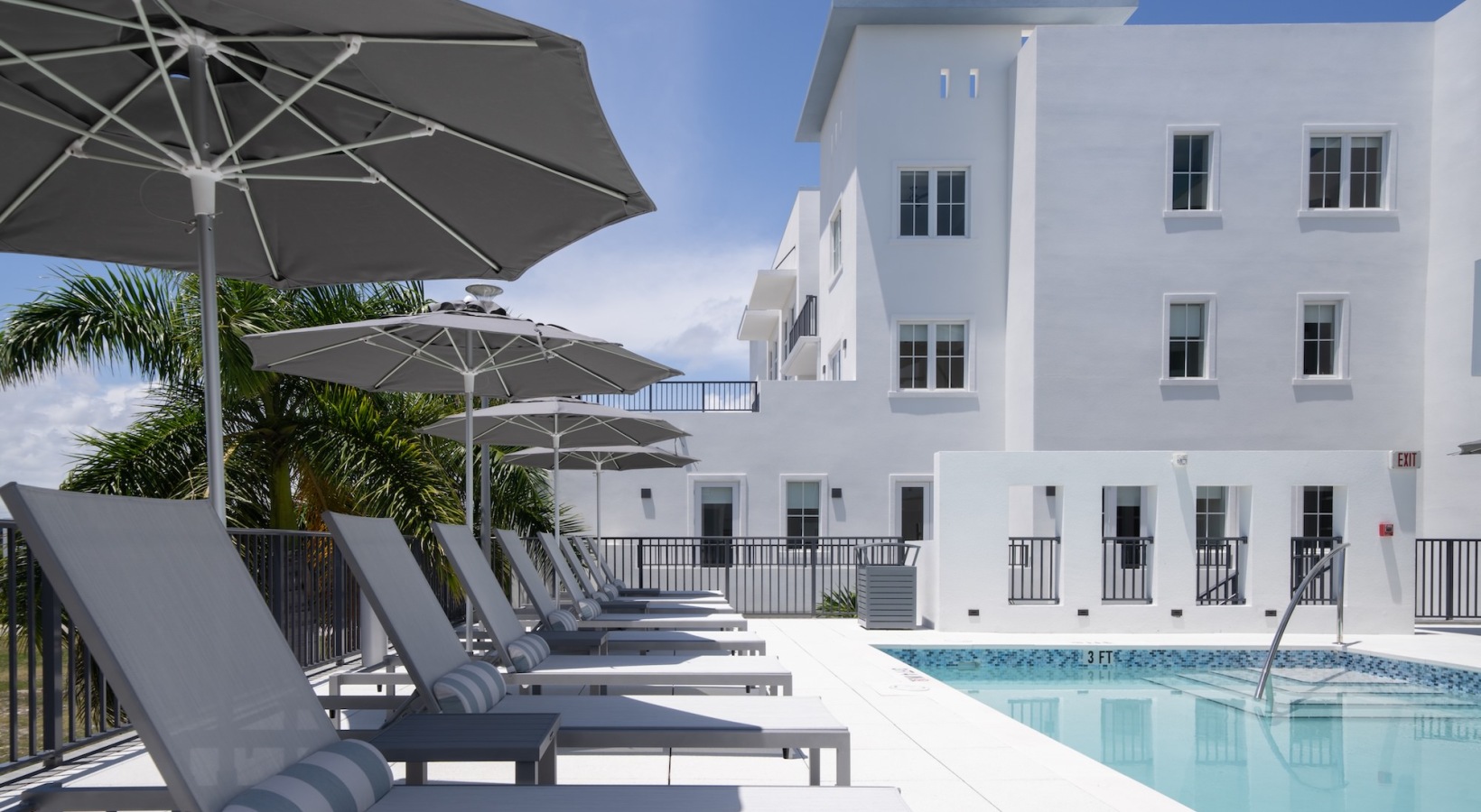 Resort-style swimming pool with lounge seating